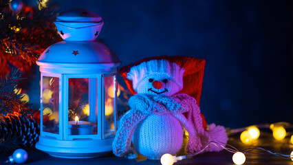 Canvas Print - white Christmas lantern with fir branches and a snowman. Festive background with copy space