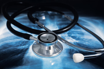 Medical Phonendoscope on a lung X-ray of a patient. Stethoscope to auscultate patients over torax radiography for diagnosis of lung diseases