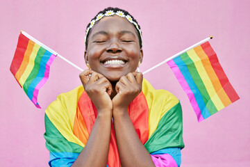 Pride, lgbtq and black woman with flags in studio for queer rights. Freedom, homosexual and face of happy, lesbian or bisexual female from Nigeria with rainbow flag showing support for gay community.