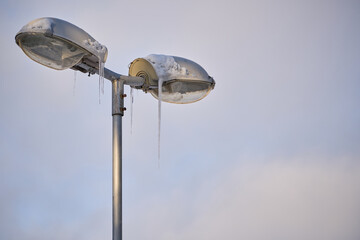 city lighting covered in icicles isolated on sky