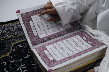 little girl reading the Quran. Islamic concept