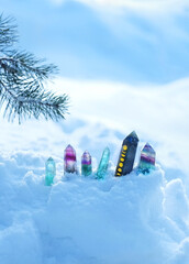 Wall Mural - crystals gemstones and pine branch on snow, natural winter background. minerals for esoteric Crystal Ritual, Witchcraft. spiritual energy practice in winter season. 