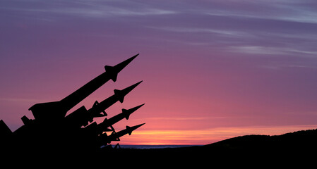 Wall Mural - The missiles are aimed to the sky at sunset. Nuclear bomb, chemical weapons, missile defense, a system of salvo fire.