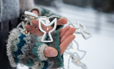 Sticker - woman holding Christmas decoration in snow