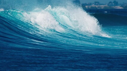 Wall Mural - Powerful crystal clear ocean wave breaks on the shore in the Maldives