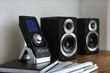 © New Africa - Modern powerful audio speakers and remote on table indoors