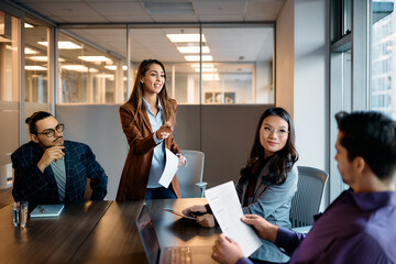 Group of multiracial colleagues brainstorming during business meeting in office.