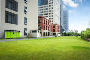 Poster - Modern urban business buildings behind lawn