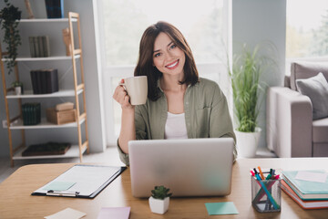 Sticker - Photo of cheerful attractive person hand hold fresh coffee mug use netbook spacious modern office indoors