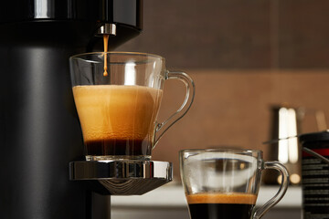 Closeup of a glass cup with fresh coffee from a capsule coffee machine