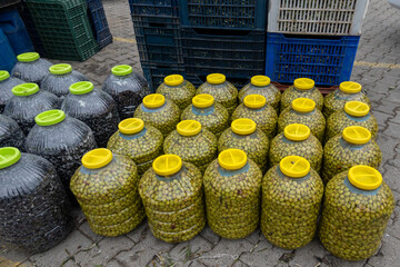 Wall Mural - Fresh black olives in a plastic jar. Olives on the sales counter ready for sale.