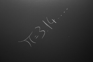 PI number concept. Math formula drawn with chalk on the chalkboard.