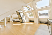 An Attic Style Room With Wood Floors And Skylights On The Roof, Looking Towards The Living Area To The Bedroom