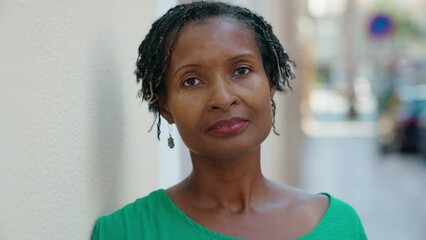 Canvas Print - Middle age african american woman standing with serious expression at street