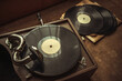 © Svetliy - Mechanical gramophone with a wind-up handle for playing records. Vintage music music player. Retro disco.The records are on the table.