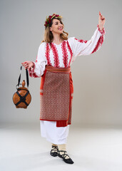 Wall Mural - Woman in Romanian traditional costume on gray