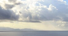 Clouds Moving Over The Smooth Sea, Reflection Of The Sun's Rays Timelapse.