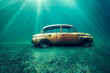 © XaMaps - An old car submerged in the seabed, lit up by sunlight coming through the surface of the water. Perfect for illustrating the aftermath of an automotive accident.