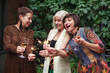 Group of Senior women Friends celebrate, have fun with sparklers and clink glasses of alcohol wine or champagne at outdoor party
