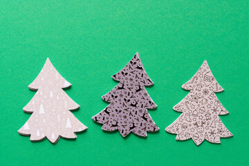 Sticker - three sets of stylized paper holiday trees on green