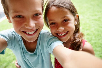 Wall Mural - Sibling selfie. Shot of a young brother and sister taking a selfie in the garden.