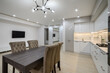 Huge white luxury kitchen in a studio apartment interior