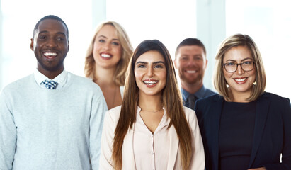 Poster - They have come a long way together. Portrait of a group of confident work colleagues standing together against a white background.