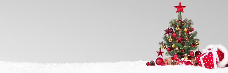 Wall Mural - christmas tree with decoration on a winter background.