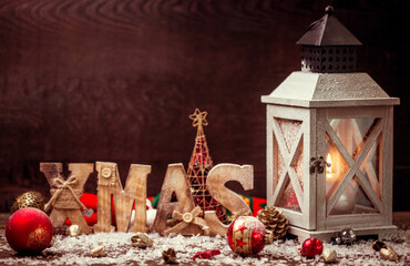 Wall Mural - christmas lantern on snowy table with festive decoration.