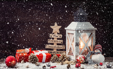 Wall Mural - christmas lantern on snowy table with festive decoration.