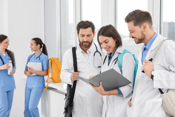 Sticker - Team of medical students in college hallway, space for text