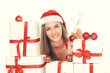 © yurolaitsalbert - beautiful young woman in Christmas suit with a stack of Christmas gifts.