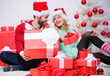 © be free - Woman and bearded man in love sit near christmas tree background. Christmas eve with darling. Love is best gift. Family married couple at home. Couple in love enjoy winter holiday celebration