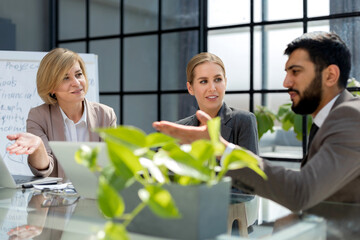 Poster - Group of business partners discussing ideas and planning work in office.