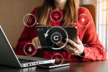 Wall Mural - Copyright or patent concept, Person hand using laptop computer, tablet and smartphone with virtual screen copyright icon trademark, Creation ownership against piracy.