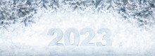 New Year Card With Ice Number 2023 On Snow. Snow Covered Spruce Branches With Christmas Blurred Garland Lights On The Banner. Beautiful, Winter, Holiday Background With A Copy Space.