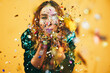 © DisobeyArt - Hppy girl blowing confetti - Party and new year's eve concept - Focus on hands holding confetti