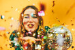 canvas print picture - Happy girl blowing confetti holding vintage disco ball while celebrating new year's eve - Party concept - Focus on face
