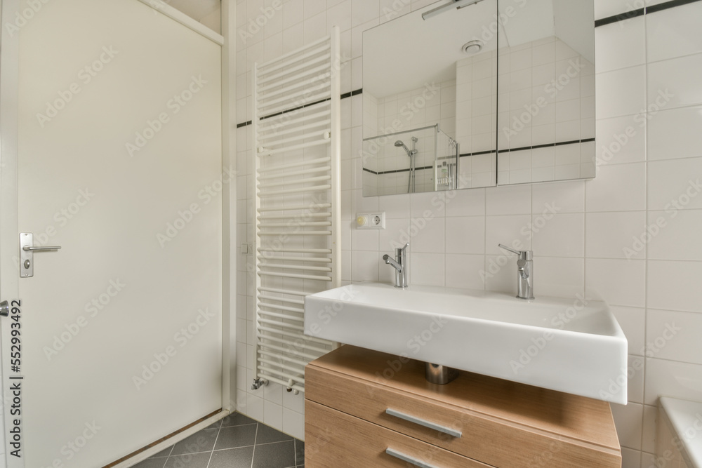 Glass partition between shower tap and wall hung toilet in modern restroom at home