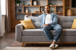 © Prostock-studio - Domestic Comfort. Smiling Young Black Man Resting On Sofa In Living Room