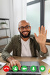 © Prostock-studio - Web conference concept. Happy latin man making video call via laptop and waving to webcamera, screenshot view