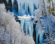 A Beautiful Frozen Waterfall Rises About An Ice-covered Forest