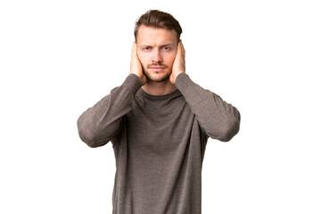 Wall Mural - Young handsome caucasian man over isolated chroma key background frustrated and covering ears