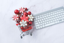 Christmas Holiday Background. Snowflakes Gingerbread Cookies In Shopping Cart And Keyboard On Marble Table. Christmas Sale, Shopping Time, Boxing Day Concept. Winter Festive Season. Flat Lay