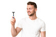 © luismolinero - Young caucasian man shaving his beard  over isolated chroma key background with happy expression