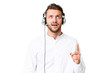 © luismolinero - Telemarketer caucasian man working with a headset over isolated chroma key background pointing up and surprised