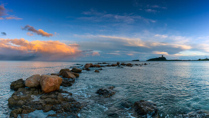 Canvas Print - sunset at Nora Beach in Sardinia with the Coltellazzo Tower in the background