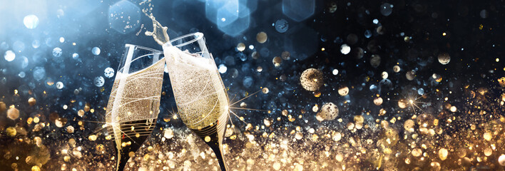 Wall Mural - Christmas background with glasses of champagne and shiny golden background. Festive New Year's Eve Party