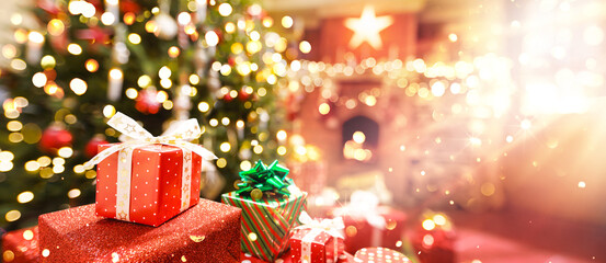 Wall Mural - christmas tree with gifts near the fireplace in bright sunlight. santa claus christmas magic room
