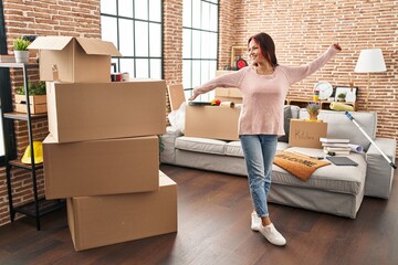 Young caucasian woman smiling confident standing at new home